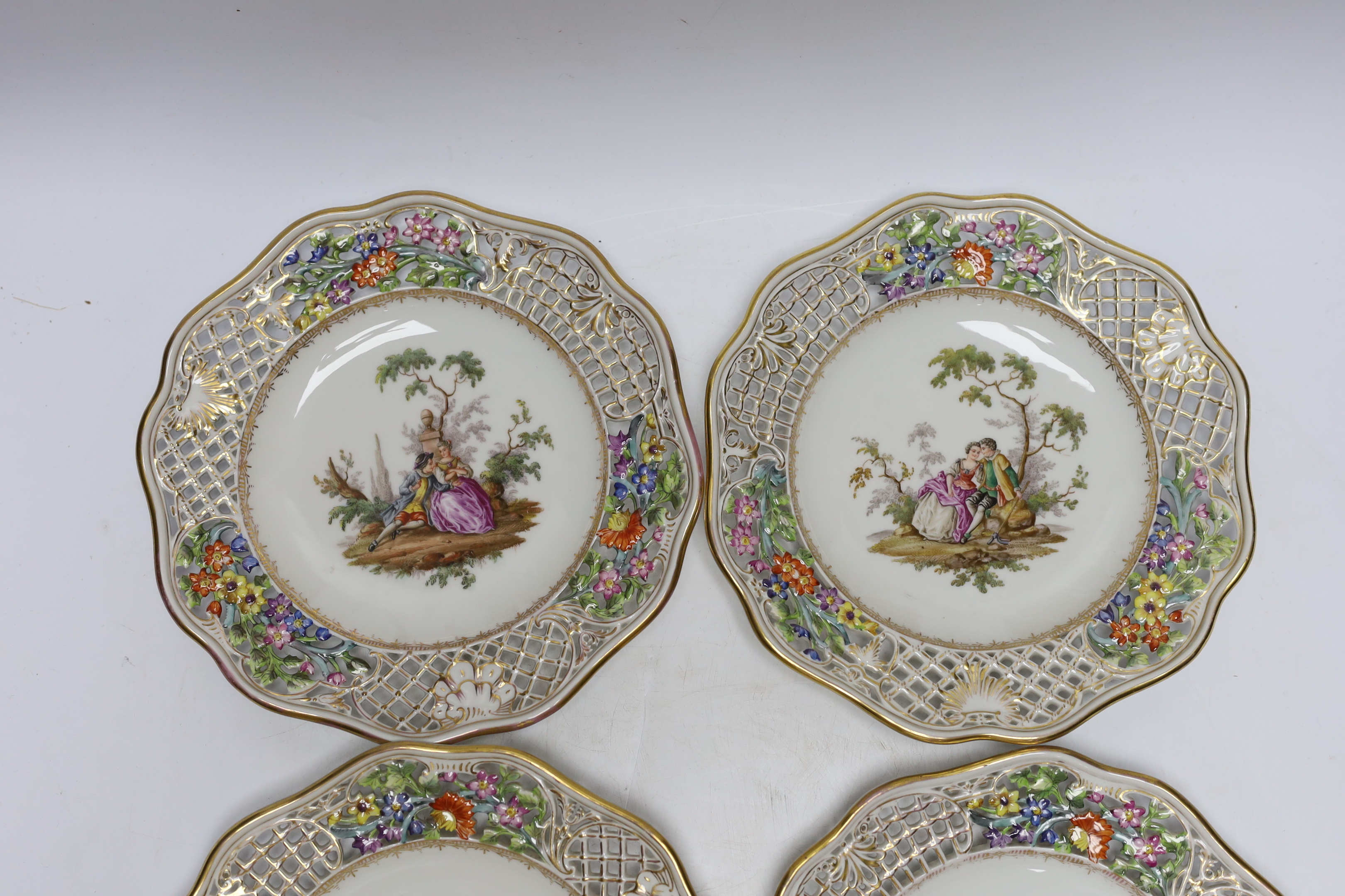 A set of four Dresden cabinet plates decorated with lovers, 22cm high